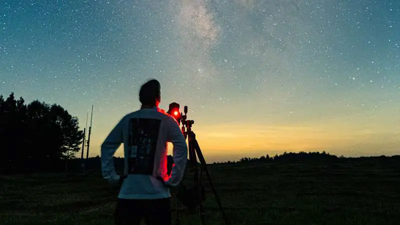 Person using a telescope to find Saturn